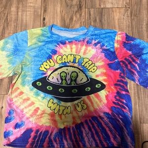Tye Dye shirt, says "you cant trip with us"
